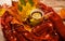 Autumn warm composition in red tones on a wooden background with a cup of tea, garland