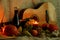 Autumn warmth card. Stll life harvest thanksgiving. Pumpkin, pears, apples, grapes and candles soft light on sack cloth