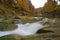 Autumn waterfall on mountain river