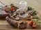 autumn winter still life sausages chili pepper in glass spice jar wooden scoop basil leaves tomatoes and rovan berries on wooden