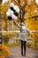Autumn woman in autumn park with balloons. Fashion girl in gray coat