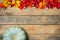 Autumn wooden background with yellow-red and green leaves, pumpkin and chestnut. Composition on a natural table made of