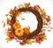 Autumn wreath of twigs, leaves, red berries and pumpkins