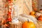 Autumn yellow leaves, pumpkins, autumn, barrel, lamp, straw, wooden door on the background.