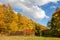 Autumnal colorful landscape under cloudy sky