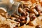 Autumnal composition of some chestnuts over some fallen leaves and a crystal bottle