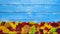 Autumnal frame on blue wooden background , stop motion animation,