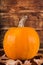 Autumnal Harvest: Vibrant Pumpkin and Rustic Wood