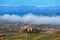 Autumnal hills and morning fog on background.