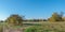 Autumnal rural countryside with fall foliage, trees, meadow, grass and a path fork