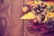 Autumnal still life with acorn pinecone and yellow leaves on wooden board