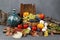 Autumnal still life with a rustic jug, fruits, pine bark and leaves