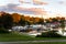 Autumnal Sunset over a Harbour with Boats Moored ot Wooden Piers