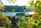 Autumnal view through branches to schliersee lake and church