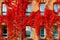 Autumnal view of red brick building covered by red foliage of parthenocissus