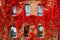 Autumnal view of red brick building covered by red foliage of parthenocissus