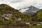 Autumnal view of the town of Isaba with the mountain and its peak in the background surrounded by clouds, in the Navarrese