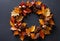 An autumnal wreath made from leaves and acorns.