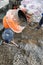 auxiliary worker develops a cement mortar in a concrete mixer at the construction of a country house