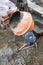 auxiliary worker develops a cement mortar in a concrete mixer at the construction of a country house