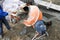 auxiliary worker develops a cement mortar in a concrete mixer at the construction of a country house