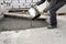 auxiliary worker pours out of a bucket liquid cement mortar on the floor between the floors of the house