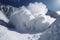 avalanches in slow motion, with billowing clouds of snow and dust