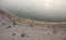 Aveiro, Portugal - Agosto 2018: Aerial view of peaceful Barra Beach with few people. Gentle waves and sun glare in water