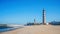 Aveiro, Portugal - March 2019: Barra beach during a cloudless sky day, with the Lighthouse of Praia da Barra.