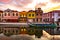 Aveiro, Portugal, Traditional colorful Moliceiro boats docked in the water canal along Cais dos Mercanteis street