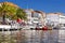 Aveiro, Portugal â€“ May 3, 2019:  Moliceiro traditional colorful boats docked along the central canal with houses in Aveiro.