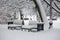 Avenue with a row of benches during strong wind and snowstorm at winter in Moscow, Russia. Scenic view of a snowy city