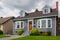 Average residential house with green lawn on cloudy day in Canada