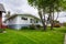 Average residential house with old trees in front