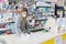 Avetrana, Italy, - Marth, 13, 2020. Saleswoman cleaning counter with disinfectant liquid with alcohol. Respecting health standards