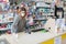 Avetrana, Italy, - Marth, 13, 2020. Saleswoman cleaning counter with disinfectant liquid with alcohol. Respecting health standards