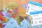 Avia tickets on world map, flat lay. Travel agency concept