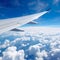 aviation as an airplane\\\'s wing soars through the vast, clear blue sky.