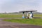 Aviation fuel filling station on airport with airfield runway in background