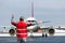 Aviation Marshall / Supervisor meets passenger airplane at the airport