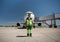 Aviation marshaller posing at airport and holding signal wands