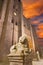 Avila - The Facade of Catedral de Cristo Salvador at dusk and the lion staute