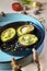 Avocado baked with quail eggs, fresh onion