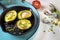 Avocado baked with quail eggs, fresh onion