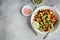 Avocado, black bean, corn and bell pepper salad in white bowl