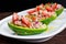 Avocado boats stuffed with tuna, red onion and cherry tomatoes.