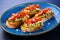 avocado bruschetta with sesame seeds on a blue rimmed plate