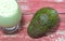 Avocado cream on the wooden surface with fresh fruits and leaves