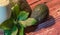 Avocado cream on the wooden surface with fresh fruits and leaves