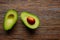 Avocado cut on aged wood table board